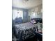 A bedroom with a bed, black tufted headboard, posters, and natural light from a window at 3401 E Paradise Ln, Phoenix, AZ 85032