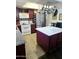 A bright kitchen featuring an island, stainless steel refrigerator, and hanging pot rack at 3401 E Paradise Ln, Phoenix, AZ 85032