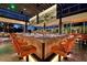 Large restaurant bar with orange barstools and a modern design at 6166 N Scottsdale Rd # C3006, Paradise Valley, AZ 85253