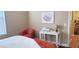 Cozy bedroom nook with a comfortable chair, desk, and colorful wall art at 7027 N Scottsdale Rd # 237, Scottsdale, AZ 85253