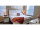 Bright bedroom featuring a white bed frame, warm lighting, and stylish decorative accents at 7027 N Scottsdale Rd # 237, Scottsdale, AZ 85253