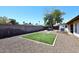 Large backyard with low-maintenance gravel, artificial grass, and outdoor seating area at 1531 W Plana Ave, Mesa, AZ 85202
