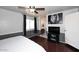 Comfortable bedroom with stylish decor, ceiling fan, and en suite bathroom access at 1531 W Plana Ave, Mesa, AZ 85202