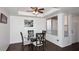 Dining area with a glass table, four chairs, and a modern ceiling fan at 1531 W Plana Ave, Mesa, AZ 85202