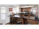 Kitchen with breakfast bar, dark countertops, wooden cabinets, and stainless steel appliances at 1531 W Plana Ave, Mesa, AZ 85202