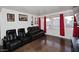 Comfortable living room with leather seating, large windows, and stylish wall decor at 1531 W Plana Ave, Mesa, AZ 85202