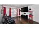 Living room featuring a TV, leather seating, guitars and a vintage-style popcorn machine at 1531 W Plana Ave, Mesa, AZ 85202