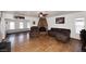 Cozy living room showcasing a brick fireplace, hardwood floors, and comfortable seating at 1531 W Plana Ave, Mesa, AZ 85202