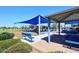 Community playground with shade structures, swings, and play equipment for children at 1531 W Plana Ave, Mesa, AZ 85202