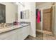 Bathroom with double sinks, granite countertops, and a glass enclosed shower at 8006 S 38Th Pl, Phoenix, AZ 85042