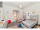 Cozy bedroom featuring two twin beds, ceiling fan, and personalized wall decor at 8006 S 38Th Pl, Phoenix, AZ 85042
