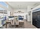 Bright kitchen with white cabinets, stainless steel appliances, and a stylish dining area at 8006 S 38Th Pl, Phoenix, AZ 85042