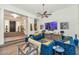 Comfortable living room with blue sofas, a large TV, and elegant decor at 8006 S 38Th Pl, Phoenix, AZ 85042