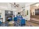 Inviting living room featuring a modern fireplace, stylish blue accents, and a cozy bar area at 8006 S 38Th Pl, Phoenix, AZ 85042