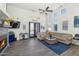 Bright living room with a fireplace, large windows, and comfortable seating at 8006 S 38Th Pl, Phoenix, AZ 85042