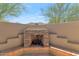 Inviting outdoor fireplace and sitting area offering a cozy retreat in the desert landscape at 8006 S 38Th Pl, Phoenix, AZ 85042