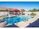 Inviting swimming pool with red umbrellas and patio furniture at 501 W Jasper Dr, Chandler, AZ 85225