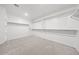 Huge walk-in closet with white shelving and plush carpet at 2957 E Cherry Hill Dr, Gilbert, AZ 85298