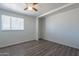 Spacious bedroom featuring wood-look floors and a large window at 3115 N 55Th Ave, Phoenix, AZ 85031