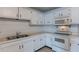 White kitchen with stainless steel sink and appliances at 3115 N 55Th Ave, Phoenix, AZ 85031