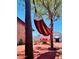 Secluded backyard featuring a hammock, lounge chairs, and a dining area at 322 N 11Th Pl, Phoenix, AZ 85006