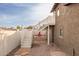 The backyard features a staircase, stone and gravel, and a red patio set at 322 N 11Th Pl, Phoenix, AZ 85006