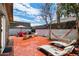 Inviting backyard with a spacious patio, lounge chairs, and a dining area with an umbrella at 322 N 11Th Pl, Phoenix, AZ 85006