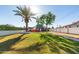 Lush backyard showcasing a well-maintained lawn, mature trees, and a glimpse of the home's exterior at 322 N 11Th Pl, Phoenix, AZ 85006