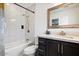 A well-lit bathroom featuring modern fixtures, tiled shower, and vanity at 322 N 11Th Pl, Phoenix, AZ 85006