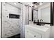 Modern bathroom with marble tile, a shower with a built-in niche, and a stylish vanity at 322 N 11Th Pl, Phoenix, AZ 85006