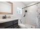 Modern bathroom featuring a tiled shower with glass doors, a stylish vanity, and clean, neutral tones at 322 N 11Th Pl, Phoenix, AZ 85006