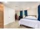 Spacious bedroom with laminate floors, natural light, and a mini fridge at 322 N 11Th Pl, Phoenix, AZ 85006