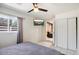 Bright bedroom featuring a ceiling fan, tiled floors, and a mounted TV at 322 N 11Th Pl, Phoenix, AZ 85006