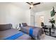 Cozy bedroom featuring two twin beds, a ceiling fan, and a minimalist decor at 322 N 11Th Pl, Phoenix, AZ 85006