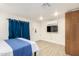 Modern bedroom offering laminate floors, ample storage, and a mounted TV at 322 N 11Th Pl, Phoenix, AZ 85006
