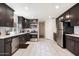 Bright kitchen featuring dark cabinetry, stainless steel appliances, and white countertops at 322 N 11Th Pl, Phoenix, AZ 85006