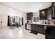 Well-lit kitchen area featuring dark cabinets, modern appliances, and an adjacent dining space with tiled floors at 322 N 11Th Pl, Phoenix, AZ 85006