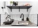 Well-equipped kitchenette featuring a sink, faucet, and open shelving for storage at 322 N 11Th Pl, Phoenix, AZ 85006