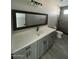 Bathroom featuring a single sink vanity with a tiled shower at 504 N 297Th Ln, Buckeye, AZ 85396