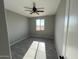 This bedroom has a ceiling fan and a window with natural light at 504 N 297Th Ln, Buckeye, AZ 85396