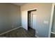This bedroom features wood-look flooring, a closet, and neutral paint at 504 N 297Th Ln, Buckeye, AZ 85396