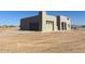 Modern home exterior featuring a three-car garage with desert landscaping at 504 N 297Th Ln, Buckeye, AZ 85396