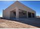 New construction home with a large covered patio, offering an outdoor living space and modern design elements at 504 N 297Th Ln, Buckeye, AZ 85396