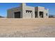 New construction house featuring a side-entry garage with a modern facade, ready for landscaping on a desert lot at 504 N 297Th Ln, Buckeye, AZ 85396