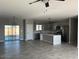 Open layout featuring a modern kitchen with stainless steel appliances and island at 504 N 297Th Ln, Buckeye, AZ 85396