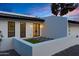 Home exterior at dusk featuring modern design, clean lines, black trim and a well-maintained front yard at 5439 S Lighthouse Ln, Tempe, AZ 85283