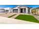 New construction home exterior with artificial turf and a paved walkway at 7386 W Bent Tree Dr, Peoria, AZ 85383