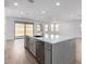 Large kitchen island with white quartz countertop and stainless steel dishwasher at 7386 W Bent Tree Dr, Peoria, AZ 85383