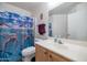 Bathroom with dolphin shower curtain and wood vanity at 14727 N Gil Balcome N Ct, Surprise, AZ 85379