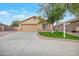 Single-story home with attached garage and landscaped front yard at 14727 N Gil Balcome N Ct, Surprise, AZ 85379